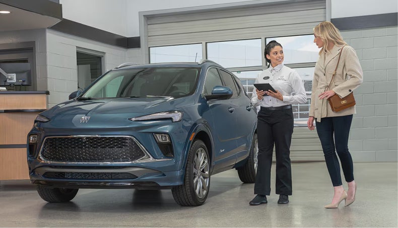 Sales person showing mother a new car